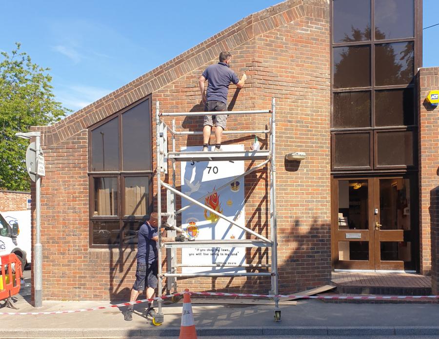 Mobile scaffolding being used to access brickwork in need of pointing